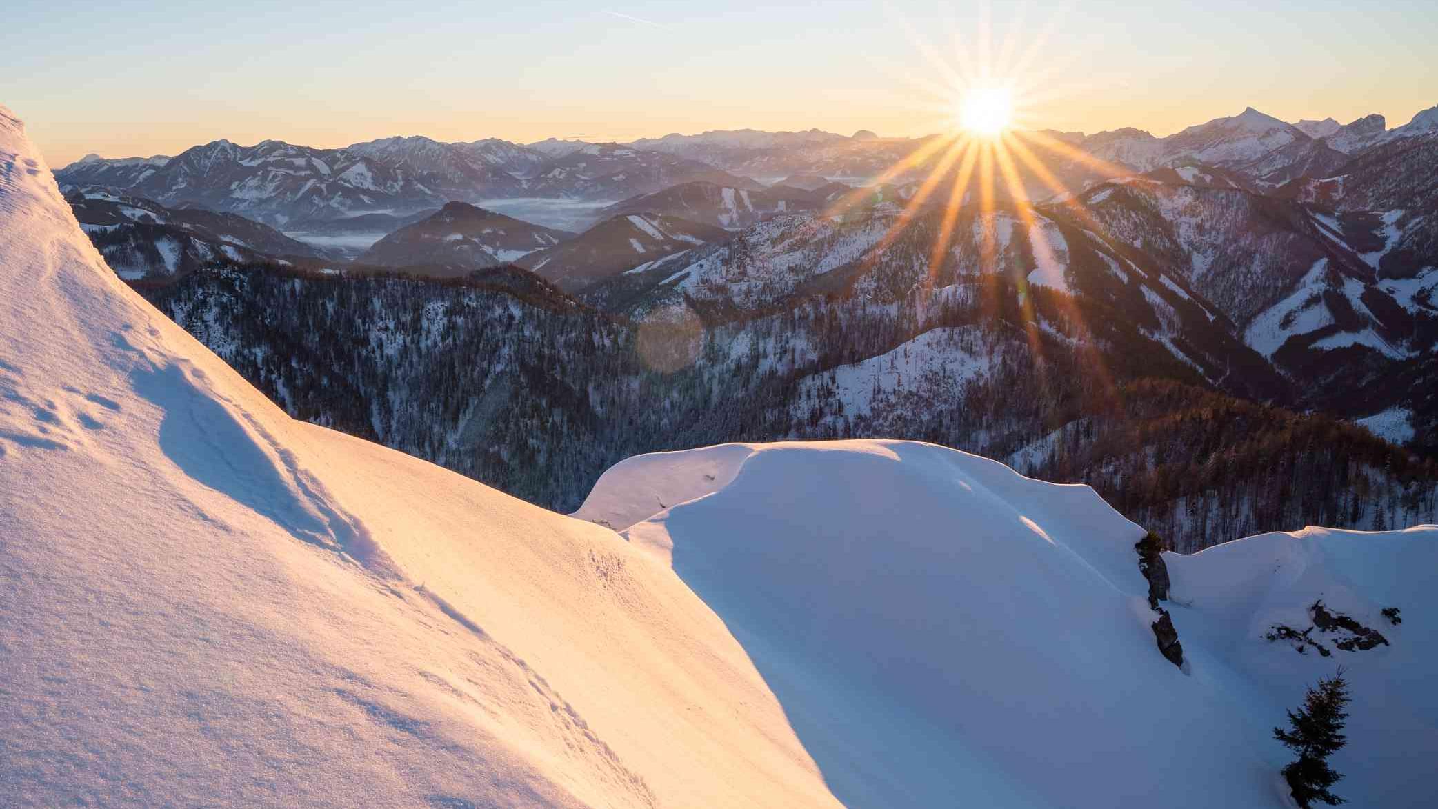Sonnenaufgang über winterlicher Bergwelt in der Nationalpark Kalkalpen Region